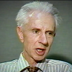 Screenshot of  Holocaust survivor Stefan Carter video testimony. He is sitting in front of a dark background and looks to the right of the camera. The camera shows his face and shoulders.